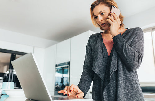 Woman managing office work from her home