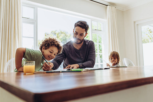 Father helping his child in doing home work