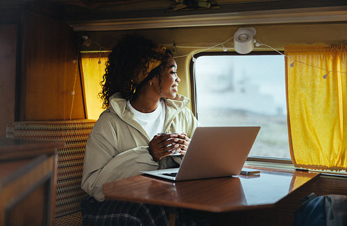 Morning in a camper van with laptop and coffee