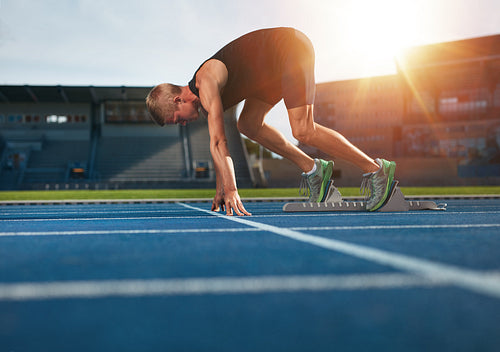 Young man on starting position about to run