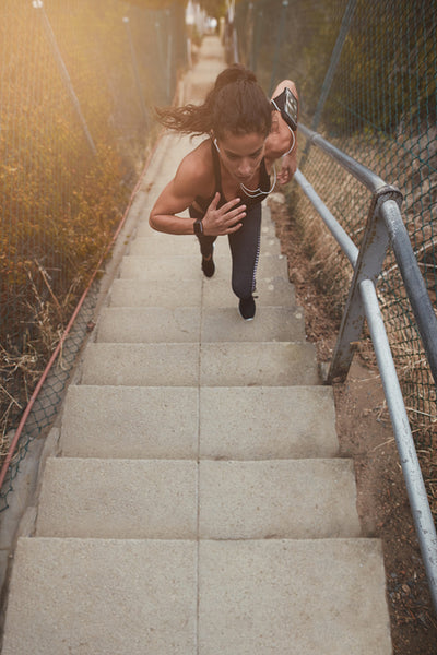 Female athlete exercising outdoors on steps