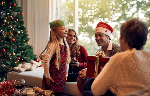 Mature woman giving a christmas gift to her granddaughter