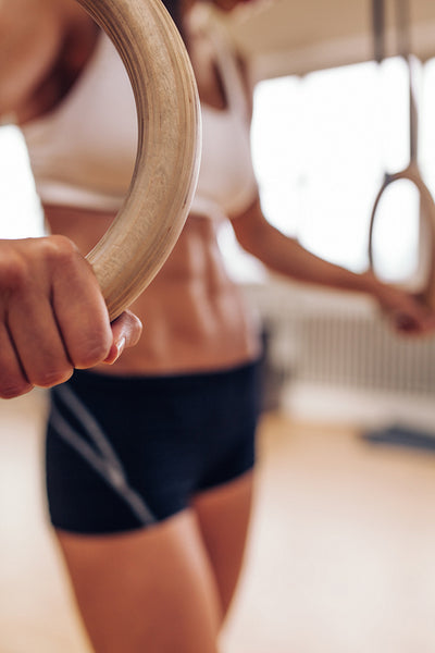 Female athlete holding gymnastic rings