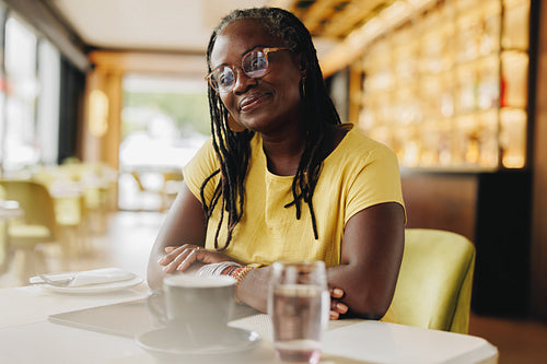 Mature woman with dreadlocks sitting in a cafe