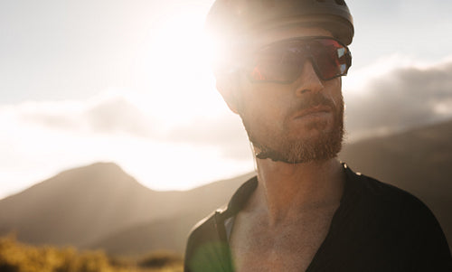 Confident cyclist standing outdoors