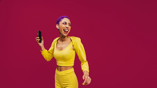 Hipster woman streaming music on her smartphone