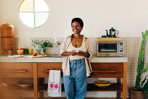Brazilian woman using her phone for online recipe in kitchen