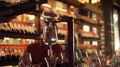 Professional sommelier decanting red wine for a private tasting room experience