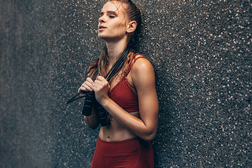 Sportswoman tired after skipping rope workout