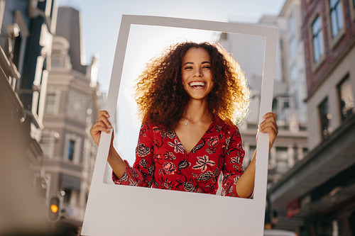 Excited girl with empty photo frame