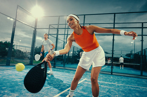 Competitive padel player in evening championship game