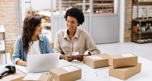 Online store owners managing their orders in a warehouse