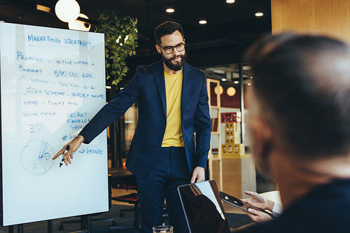 Young businessman giving a presentation during a meeting