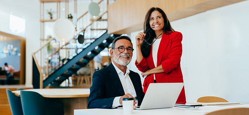 Senior professionals working at a table in a bright office setting