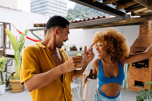 Friends enjoying a fun gathering on a rooftop patio in Brazil