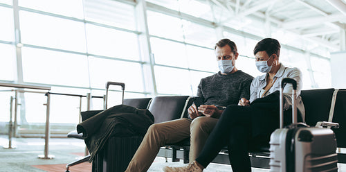 Couple of tourist waiting for their delayed flight at airport