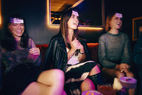 Friends enjoying a game together in a cozy, lively evening setting