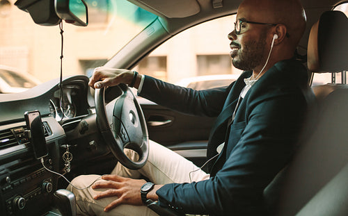 African businessman driving a vehicle to office