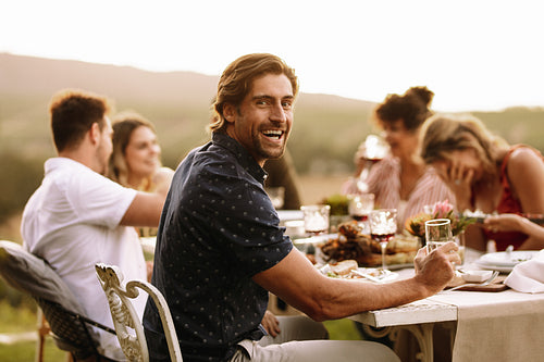Young guy enjoying at outdoor party with friends
