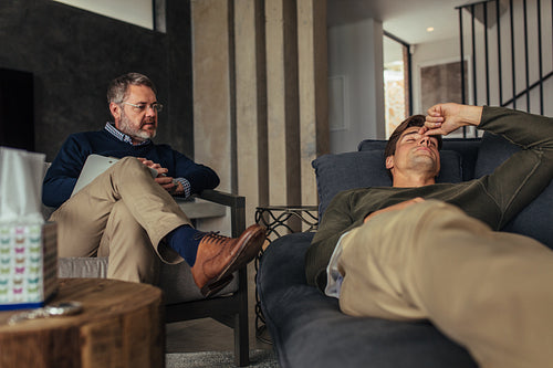 Stressed man listening psychologist's analysis