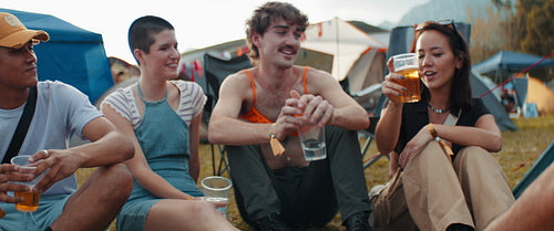 Happy vibrant friends celebrate at a music festival