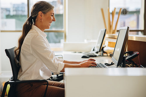 Happy businesswoman working in office