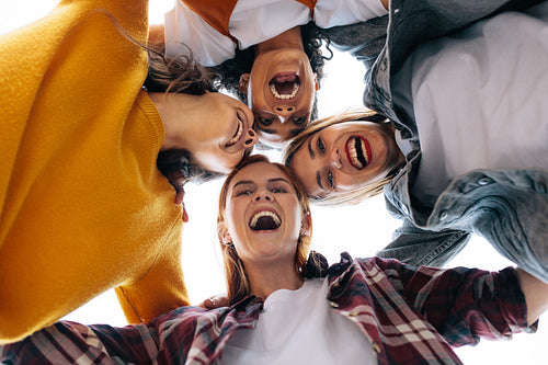 Female friends forming a huddle and having fun