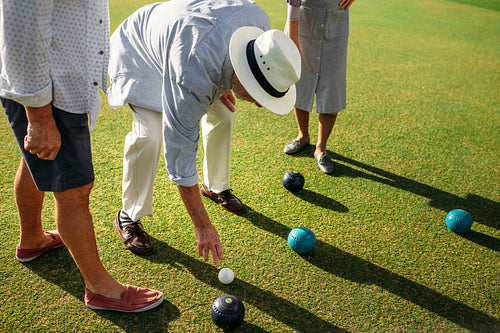 Senior people playing boules in a park