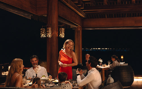 Family enjoying an elegant evening dinner at a luxury resort restaurant