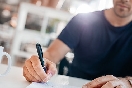 Young man hands writing in a office diary