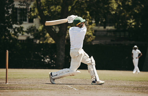 Cricketer hitting a boundary shot with precision