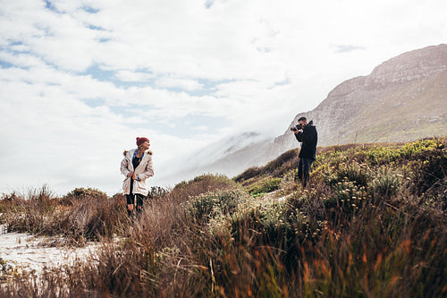 Young couple on vacation taking photos