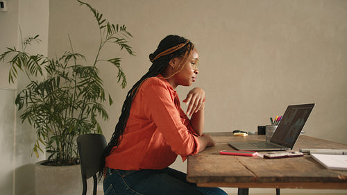 Happy female designer having a virtual meeting in her home office