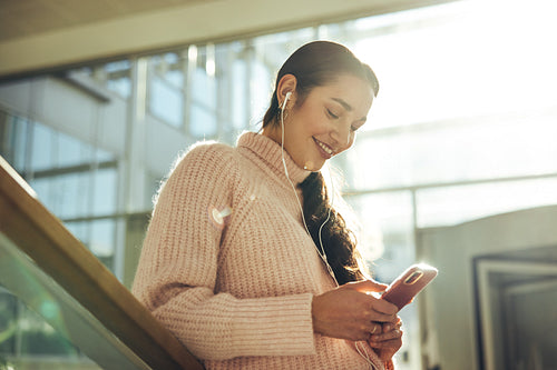 University student texting with her phone