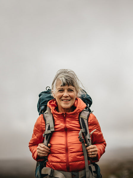 Portrait of a female hiker walking carrying a backpack