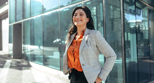 Businesswoman laughing cheerfully outside her workplace
