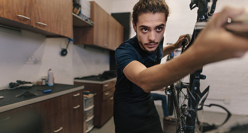 Mechanic repairing a bicycle in workshop