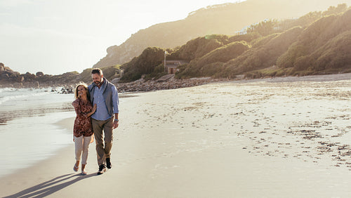 Senior couple strolling on the beach