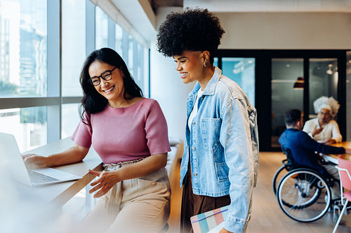 Two women collaborate at a coworking space