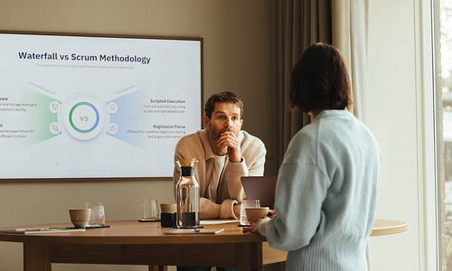 Woman presents scrum and waterfall methods during a business meeting in the office