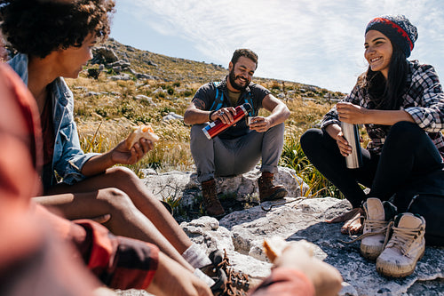 Group of hikers relaxing in field