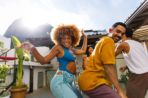 Friends dancing and enjoying funk music on a sunny day in Rio