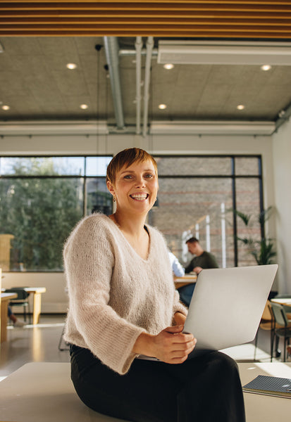 Businesswoman with laptop in office