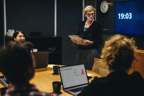 Staff briefing in office boardroom