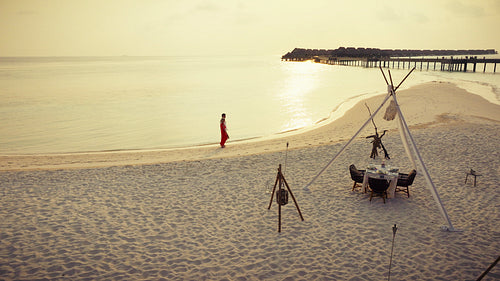 Romantic couple's luxury escape at a tropical beach resort during sunset