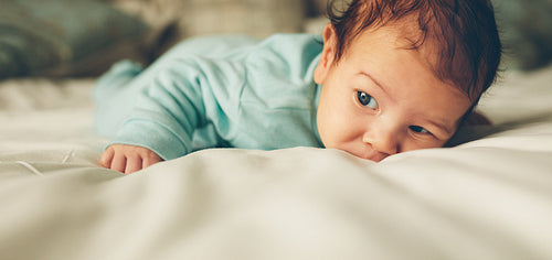 Newborn baby lying in bed