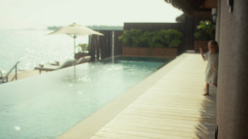 Mother and children enjoy breakfast in their luxurious villa on an island vacation