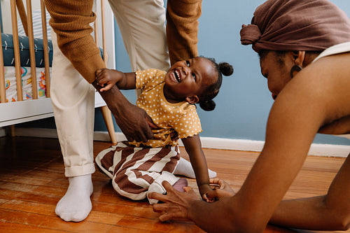 Joyful family moment as caregiver helps child
