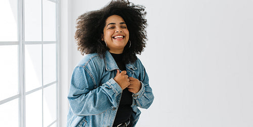 Beautiful woman in casuals looking at camera and smiling