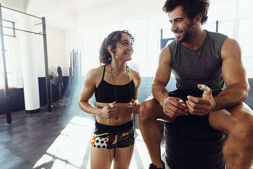 Couple at gym relaxing after heavy workout